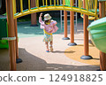 A Little Girl Playing at a Sunny Park 124918825