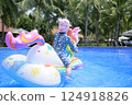 Child Riding a Float in a Resort 124918826