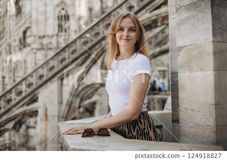 Female traveler standing on the rooftop of Duomo cathedral in Milan. Having great vacations in Milan Female traveler standing on the rooftop of Duomo cathedral in Milan. Having great vacations in Milan 124918827