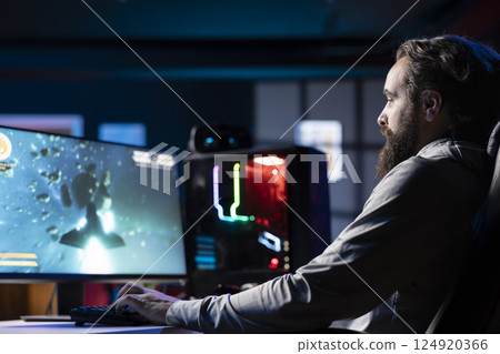 Man playing high FPS singleplayer videogame with spaceship shooting laser streams at asteroid. Gamer using crosshair overlay to hit targets in SF game with high quality graphics on powerful PC 124920366