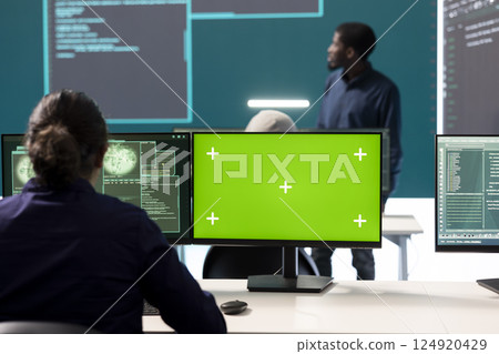 Hackers team working with a green screen layout on computer in monitoring room government center, high tech. Skilled specialists studying data for cyber warfare tactics, national security. Hackers team working with a green screen layout on computer in monitoring room government center, high tech. Skilled specialists studying data for cyber warfare tactics, national security. 124920429