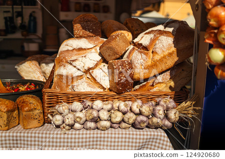 Fresh bread loaves on display at a market stand Fresh bread loaves on display at a market stand 124920680