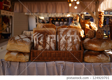Fresh bread loaves on display at a market stand Fresh bread loaves on display at a market stand 124920701