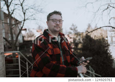 Handsome Man Looking at Camera, Close-Up Portrait with Confident Expression outdoors Handsome Man Looking at Camera, Close-Up Portrait with Confident Expression outdoors 124920761
