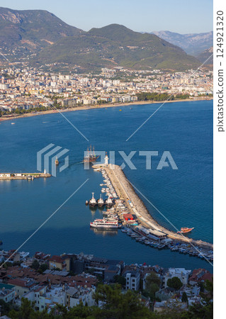 Coastal cityscape with a stunning sea view, featuring Alanya harbor Coastal cityscape with a stunning sea view, featuring Alanya harbor 124921320