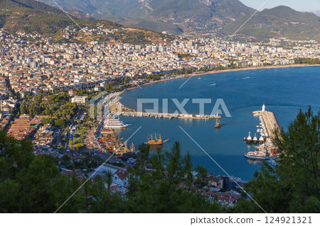 Alanya, beautiful aerial view showcasing a coastal cityscape with a harbor 124921321