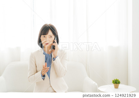 A middle-aged career woman using gestures to talk to the person on the other end of the phone A middle-aged career woman using gestures to talk to the person on the other end of the phone 124921929