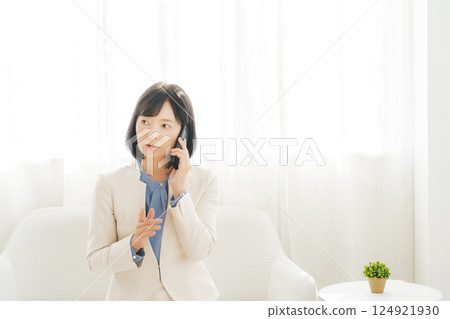 A middle-aged career woman using gestures to talk to the person on the other end of the phone A middle-aged career woman using gestures to talk to the person on the other end of the phone 124921930