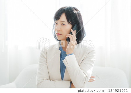 A middle-aged career woman using gestures to talk to the person on the other end of the phone A middle-aged career woman using gestures to talk to the person on the other end of the phone 124921951