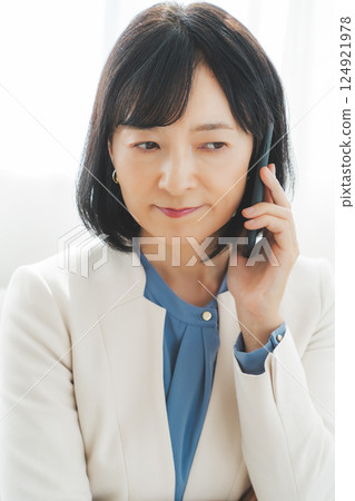 A middle-career woman struggling to communicate her thoughts to the person on the other end of the phone 124921978
