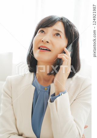 A middle-career woman struggling to communicate her thoughts to the person on the other end of the phone A middle-career woman struggling to communicate her thoughts to the person on the other end of the phone 124921987
