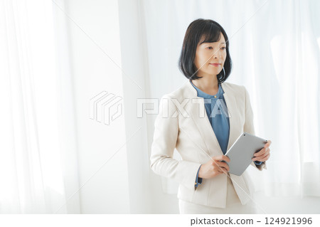 A middle-career woman pondering after looking at the results A middle-career woman pondering after looking at the results 124921996