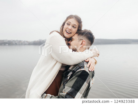 Smile with braces. Beautiful girl with braces on a date. Young people dancing, kissing and hugging, enjoying the meeting 124923388