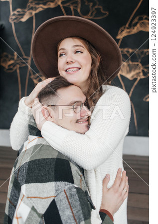 Smile with braces. Beautiful girl with braces on a date. Young people dancing, kissing and hugging, enjoying the meeting 124923397