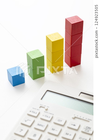 Calculator and building blocks graph on white background Calculator and building blocks graph on white background 124923505
