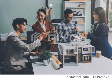 Construction, planning and architects meeting about design of building, strategy and working in industrial collaboration. Architecture workers talking about maintenance project with paper and a model Construction, planning and architects meeting about design of building, strategy and working in industrial collaboration. Architecture workers talking about maintenance project with paper and a model 124923576