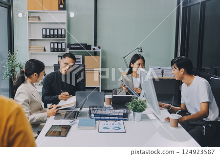 Cheerful meeting room, businesspeople celebrate with handshaking. Successful project was completed before the deadline. Business partnership and collaboration in project management. Habiliment 124923587