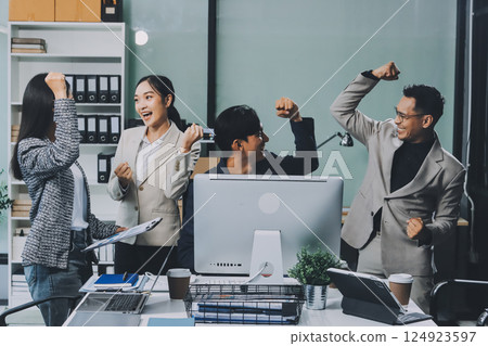 Cheerful meeting room, businesspeople celebrate with handshaking. Successful project was completed before the deadline. Business partnership and collaboration in project management. Habiliment 124923597