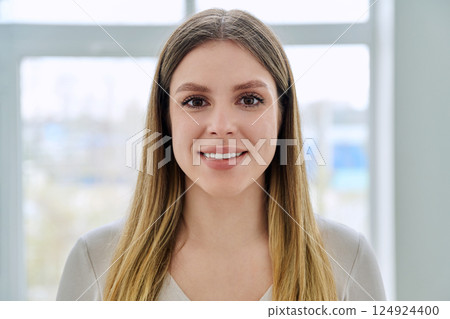 Headshot portrait of young happy woman posing in home Headshot portrait of young happy woman posing in home 124924400