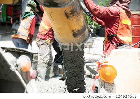 Construction work is still ongoing, such as pouring concrete. 124924513
