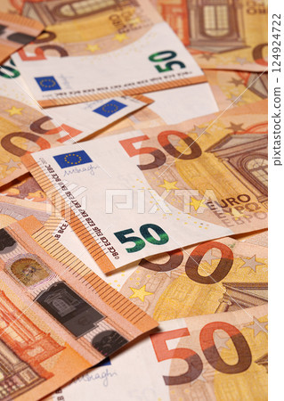 Fifty-fifty euro banknotes are scattered randomly. European currency. Studio shooting. 124924722