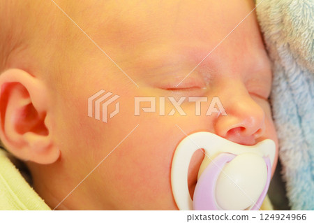 Closeup of little newborn sleeping with teat in mouth Closeup of little newborn sleeping with teat in mouth 124924966
