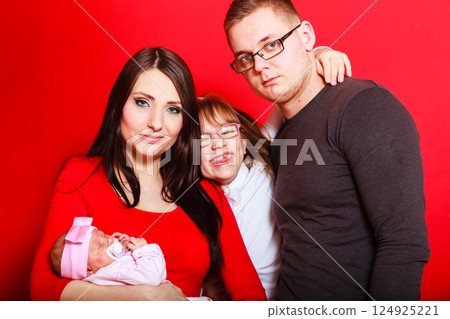 Toddler girl, father and mother holding newborn baby Toddler girl, father and mother holding newborn baby 124925221