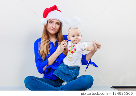 Christmas woman with cute baby. 124925560