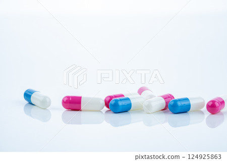 Blue and pink capsule pills spread on white background, showcasing pharmaceutical products, healthcare concepts, and the role of prescription medicine in advancing treatment and patient well-being. Blue and pink capsule pills spread on white background, showcasing pharmaceutical products, healthcare concepts, and the role of prescription medicine in advancing treatment and patient well-being. 124925863