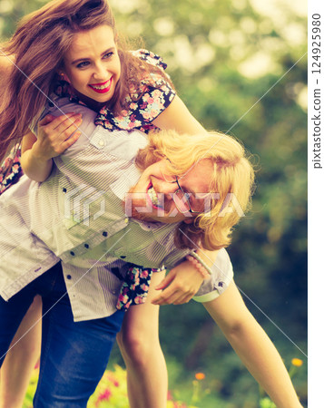 couple having fun piggyback riding couple having fun piggyback riding 124925980