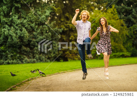 Happy couple playing in park Happy couple playing in park 124925981