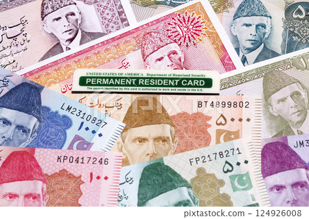 American permanent resident card on a Pakistani money 124926008