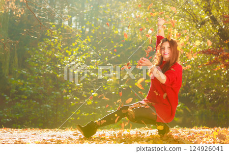 Lady playing with leaves. Lady playing with leaves. 124926041