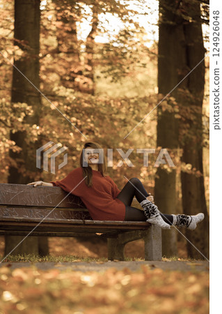 Woman relaxing on bench. Woman relaxing on bench. 124926048