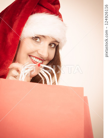 woman santa claus hat holds shopping bags 124926116