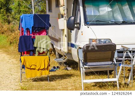 Clothes hanging to dry outdoors by camping car. Caravan vacation. Clothes hanging to dry outdoors by camping car. Caravan vacation. 124926264