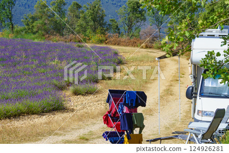 Clothes hanging to dry outdoors by camping car. Caravan vacation in France Clothes hanging to dry outdoors by camping car. Caravan vacation in France 124926281