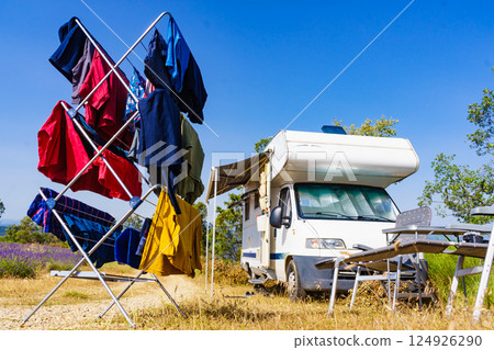 Clothes hanging to dry outdoors by camping car. Caravan vacation. Clothes hanging to dry outdoors by camping car. Caravan vacation. 124926290