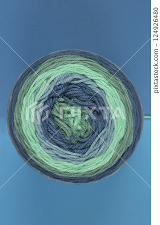 Variegated yarn cake in shades of blue and green 124926480