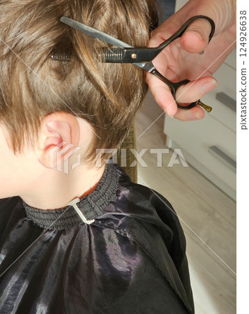 A young boy gets a new haircut A young boy gets a new haircut 124926638