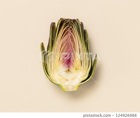 Cut raw purple artichoke on light yellow background top view. Fresh vegetables for vegetarian diet 124926988