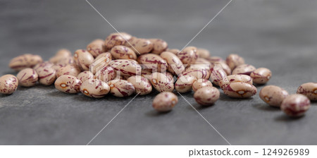 Pile of dried pinto beans on gray closeup. Traditional Latin American legumes, vegetarian food 124926989