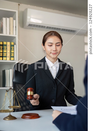 Lawyer presenting a legal contract to a client, emphasizing professionalism in the office 124928227