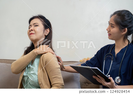 Caregiver checking symptoms of elderly patient with doctor and nurse in home environment 124928454