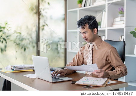 Business professional working at desk modern office digital workspace bright environment focused viewpoint productivity concept 124928487