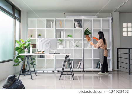 Housekeeper cleaning indoor space modern office bright environment focused viewpoint cleanliness concept 124928492