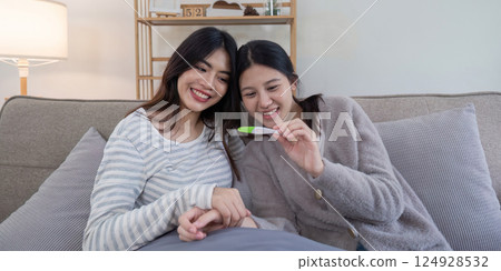 Lesbian couple celebrating ivf journey home setting emotional moment cozy environment joyful concept Lesbian couple celebrating ivf journey home setting emotional moment cozy environment joyful concept 124928532