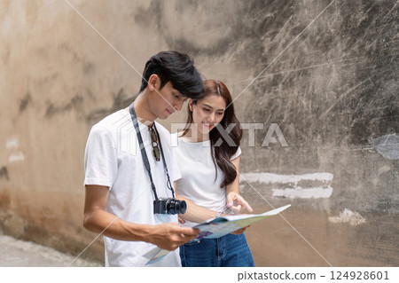 Couple a historic city travel adventure map reading urban environment candid moment discovering culture 124928601