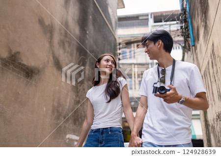 Couple traveling together urban alley lively environment romantic viewpoint adventure concept Couple traveling together urban alley lively environment romantic viewpoint adventure concept 124928639