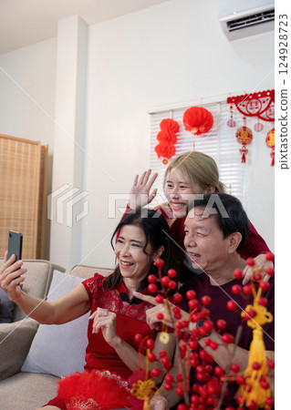 Celebrating chinese new year with family granddaughter and grandparents capture joyful moments together at home 124928723